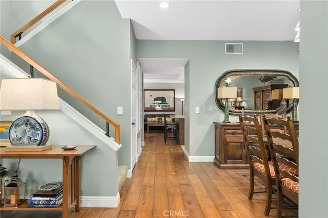 a view of a livingroom with furniture entryway and wooden floor