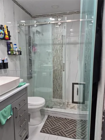 a bathroom with a toilet and a shower