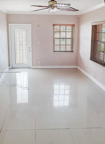 a room with wooden floor and windows