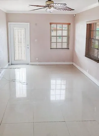 a room with wooden floor and windows