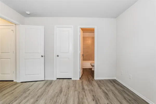 a view of a room with wooden floor and a sink