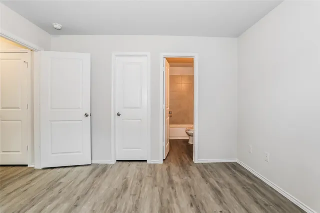 a view of a room with wooden floor and a sink