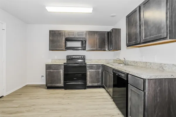a kitchen with stainless steel appliances granite countertop a sink and stove top oven
