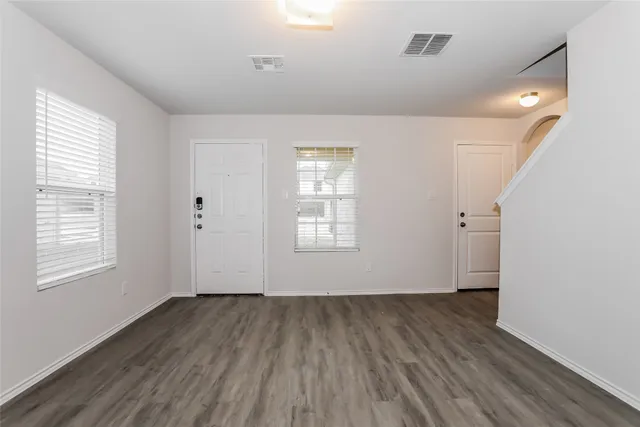 wooden floor in an empty room with a window