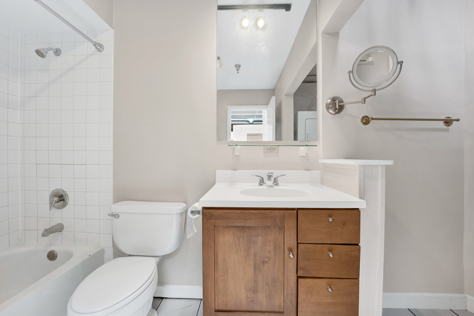 1617 South Michigan Avenue, Unit 202 Chicago, IL 60616 - Photo 11 of 14 a bathroom with a sink toilet vanity and shower