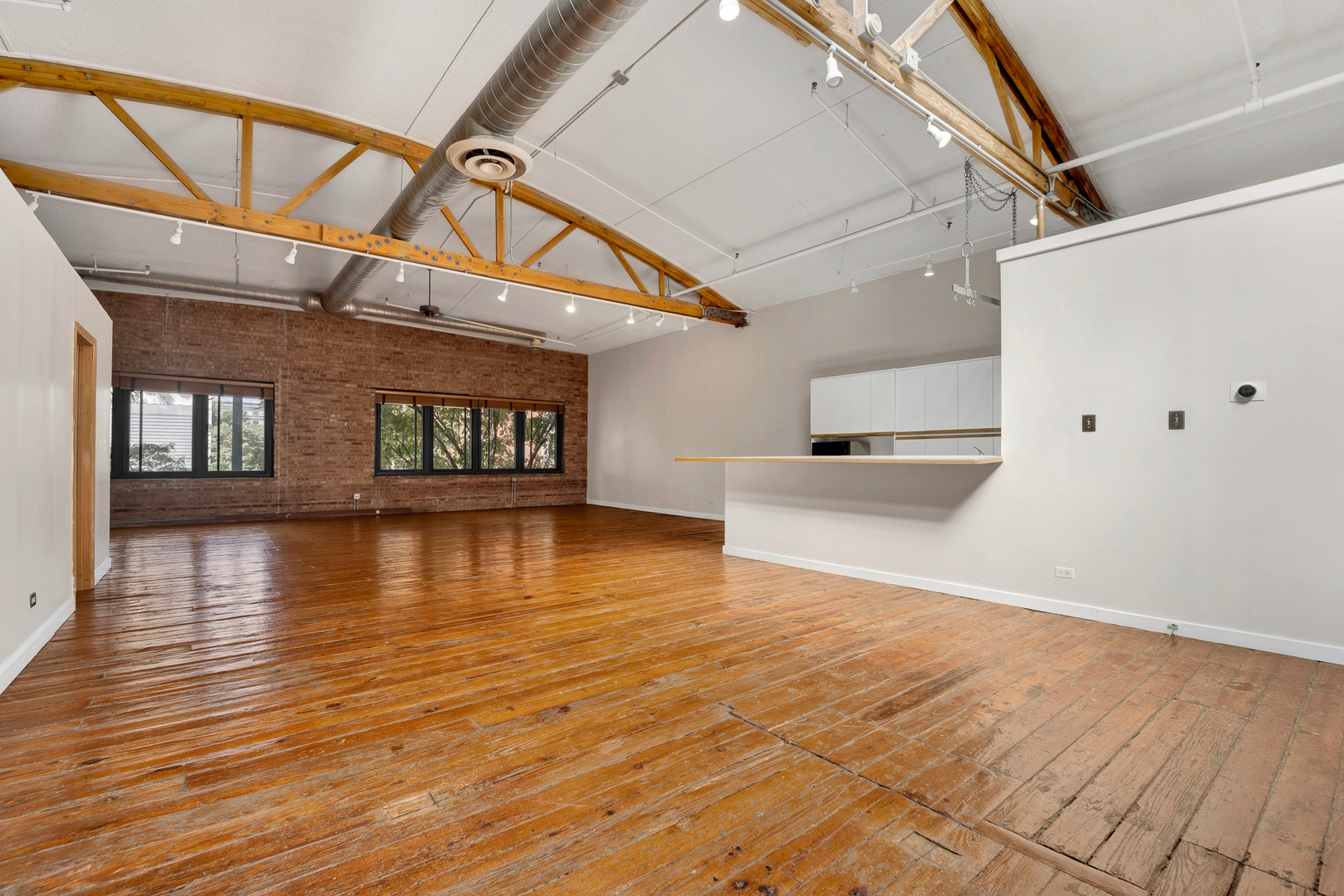 1617 South Michigan Avenue, Unit 202 Chicago, IL 60616 - Photo 6 of 14 a view of a room with wooden floors and staircase