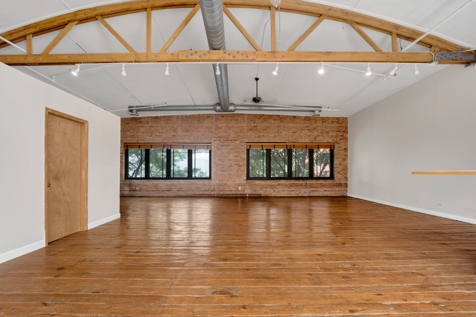 1617 South Michigan Avenue, Unit 202 Chicago, IL 60616 - Photo 7 of 14 a view of an empty room with wooden floor and a window