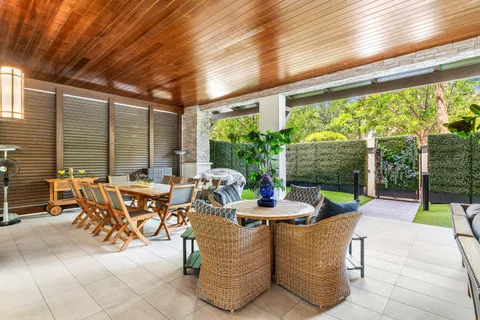 a view of a swimming pool with a patio and plants