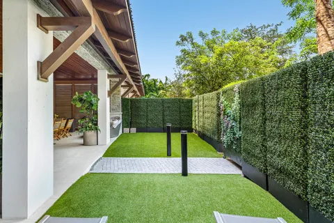 a kitchen with stainless steel appliances a dining table chairs and wooden floor