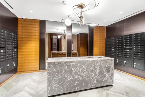 a spacious bathroom with a sink a toilet and a mirror