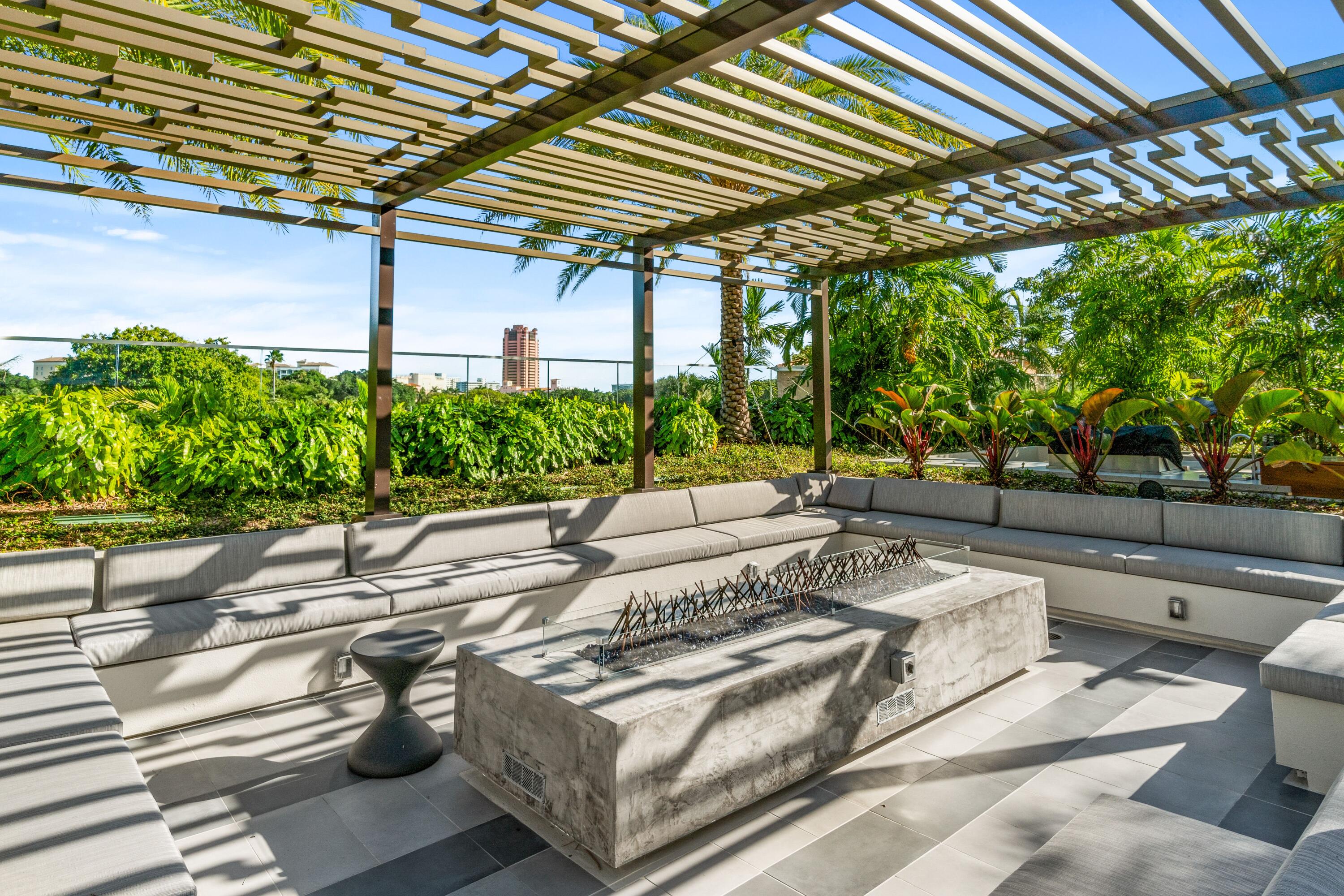 200 Southeast Mizner Boulevard, Unit 104 Boca Raton, FL 33432 - Photo 38 of 82 a view of a patio with couches and table and chairs with potted plants