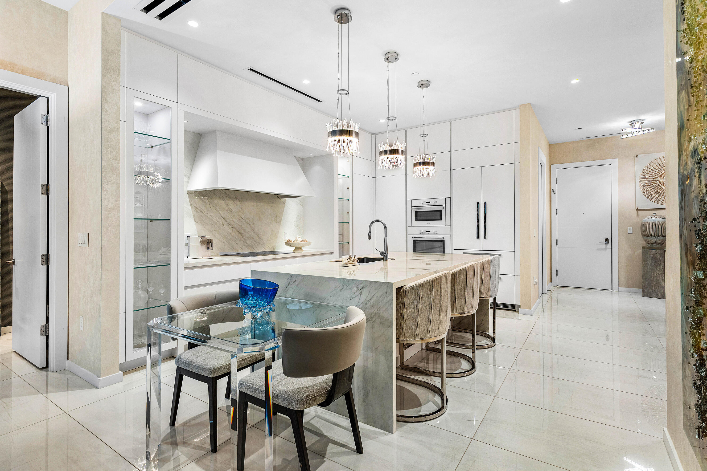 200 Southeast Mizner Boulevard, Unit 104 Boca Raton, FL 33432 - Photo 7 of 82 a kitchen with a table and chairs in it