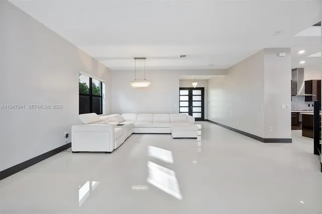 a living room with furniture and a large window