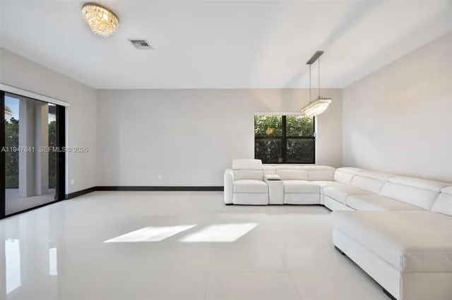 a view of a livingroom with furniture and a window