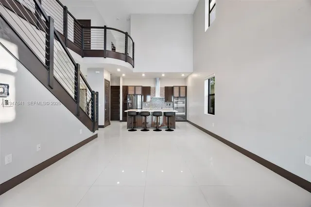 a view of a kitchen with a sink and refrigerator