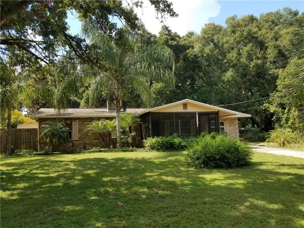 13331 Lewis Gallagher Road Dover, FL 33527 - Photo 1 of 1 a front view of a house with yard and green space