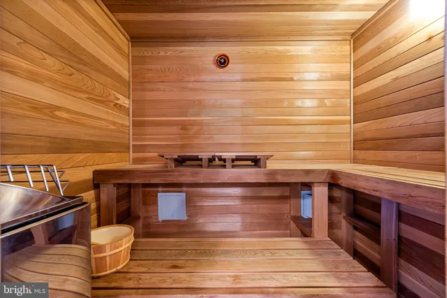 an empty room with wooden floor and a ceiling fan