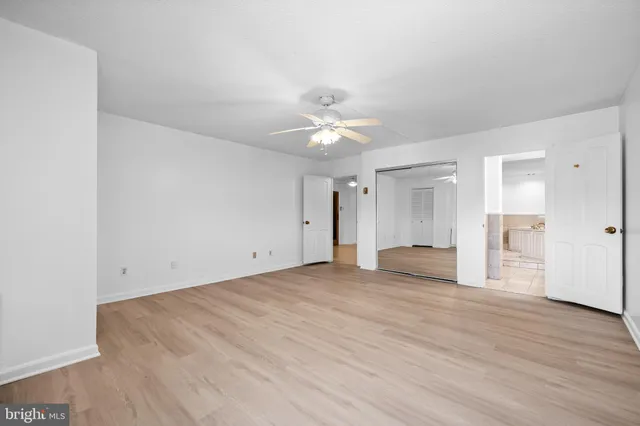 a spacious bathroom with a granite countertop double vanity sink a mirror and a bathtub