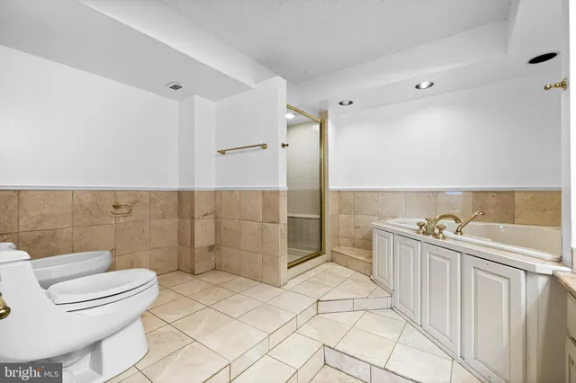 a bathroom with a bathtub and a shower