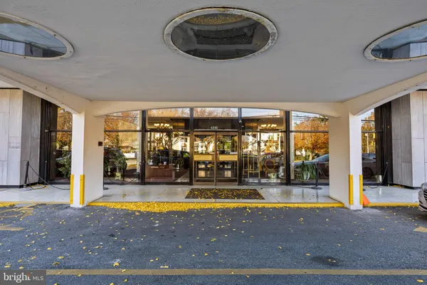 a view of a kitchen with a sink and refrigerator