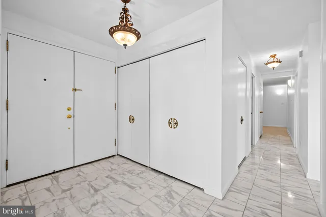 a view of an empty room with a cabinet and a living room view