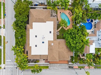 an aerial view of a house with a yard and garden