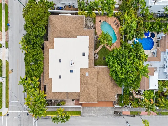 an aerial view of a house with a yard and garden