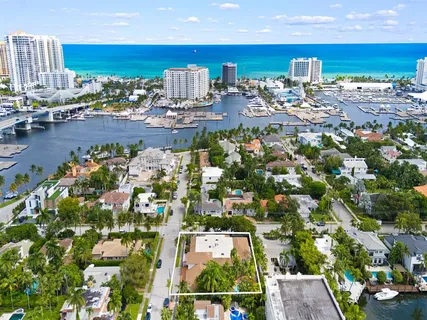 a view of a house with pool and sitting area