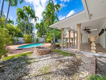 a swimming pool with outdoor seating and yard
