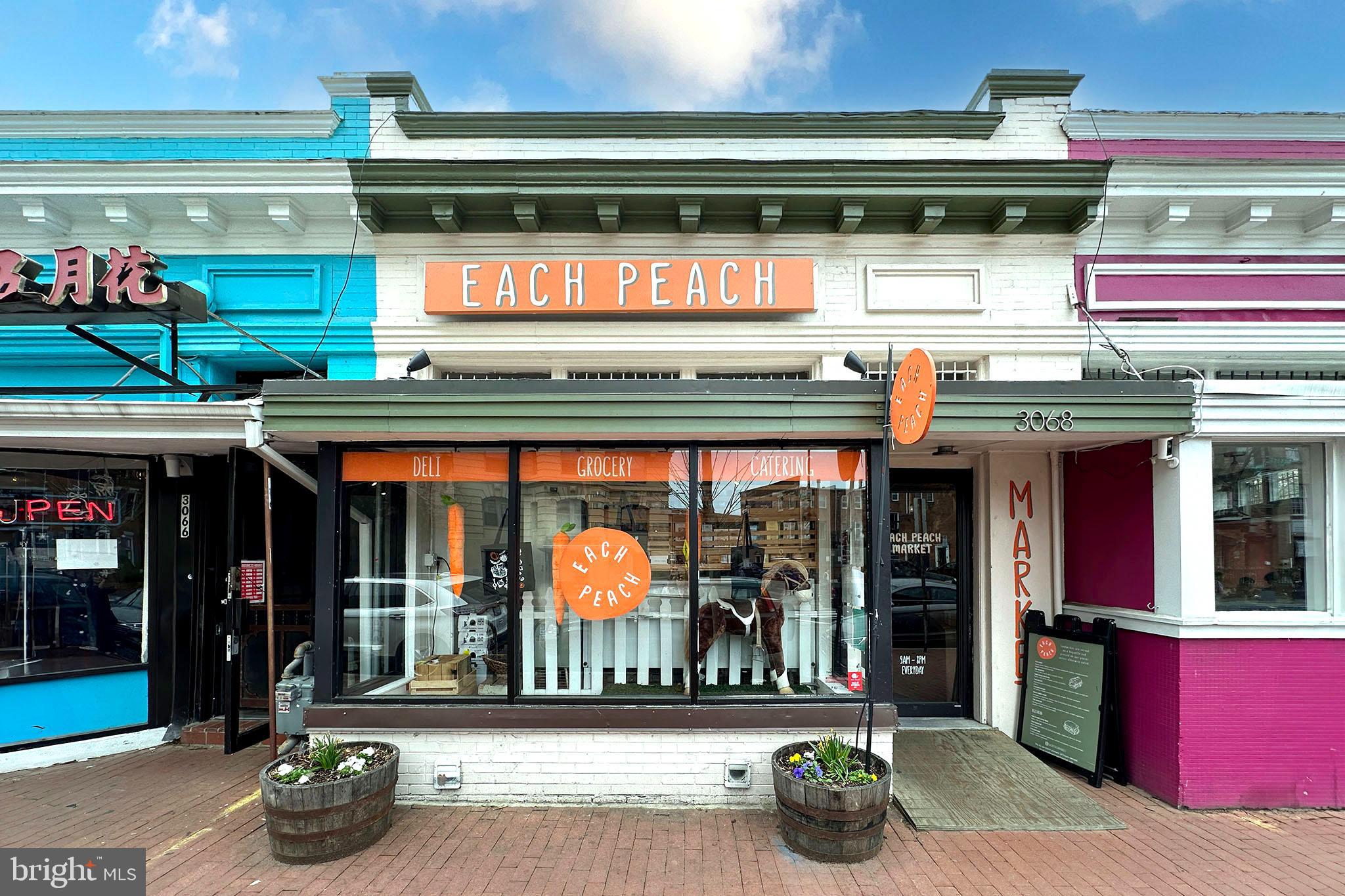 1451 Park Road Northwest, Unit 104 Washington, DC 20010 - Photo 27 of 28 a store with yellow umbrella and outdoor seating