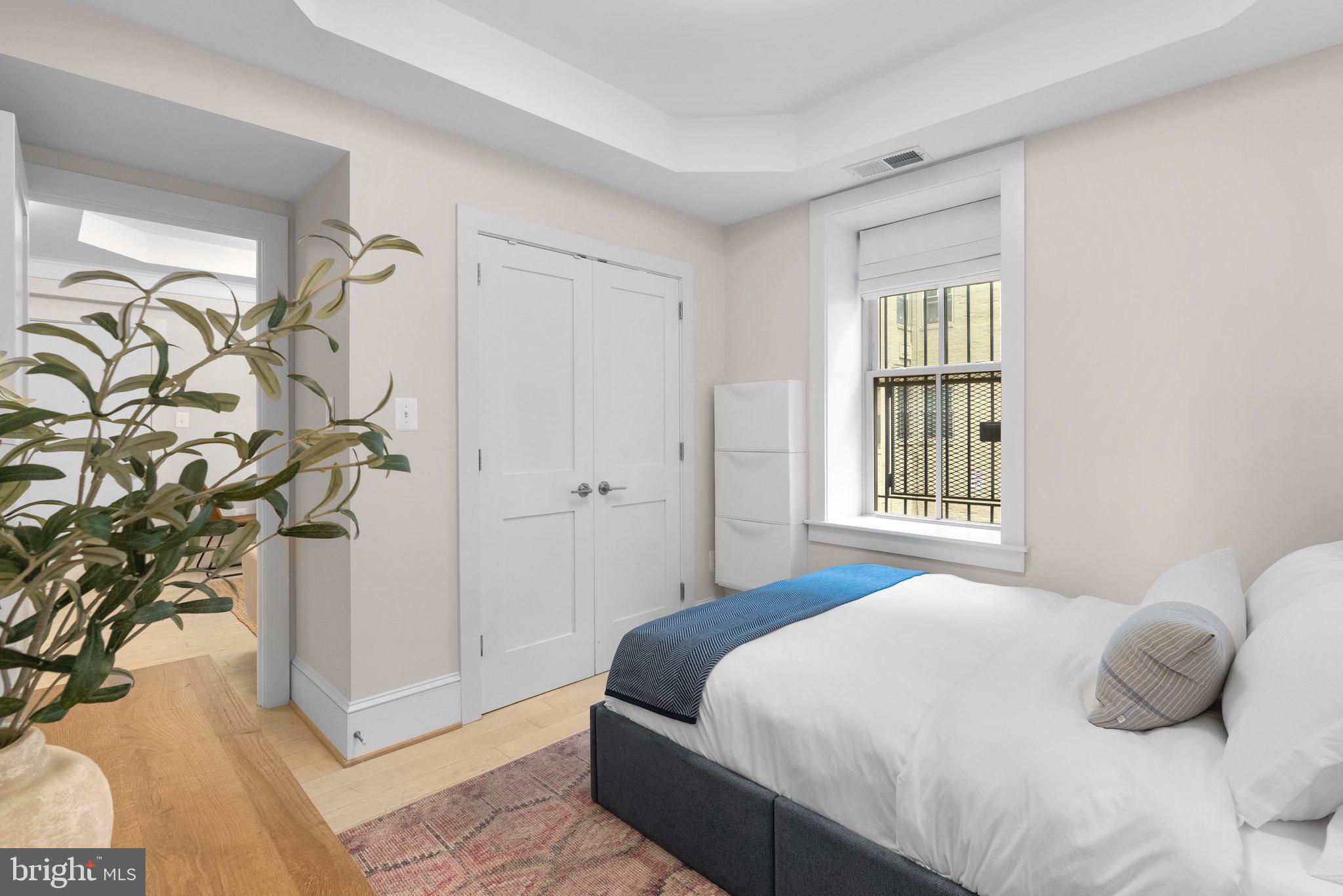 1451 Park Road Northwest, Unit 104 Washington, DC 20010 - Photo 10 of 28 a bedroom with a bed and a window