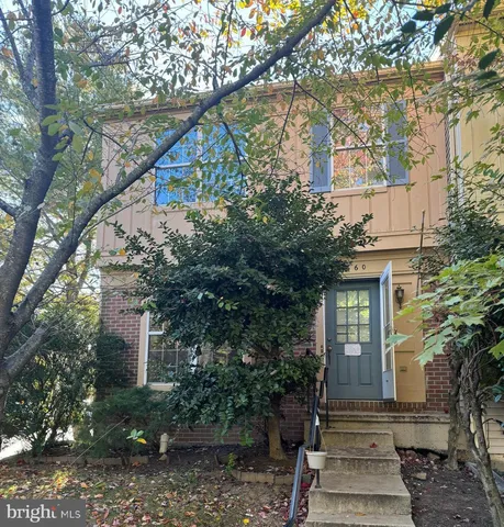 a front view of a house with trees