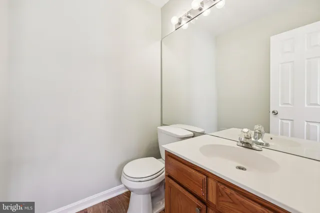 a bathroom with a sink a toilet and mirror