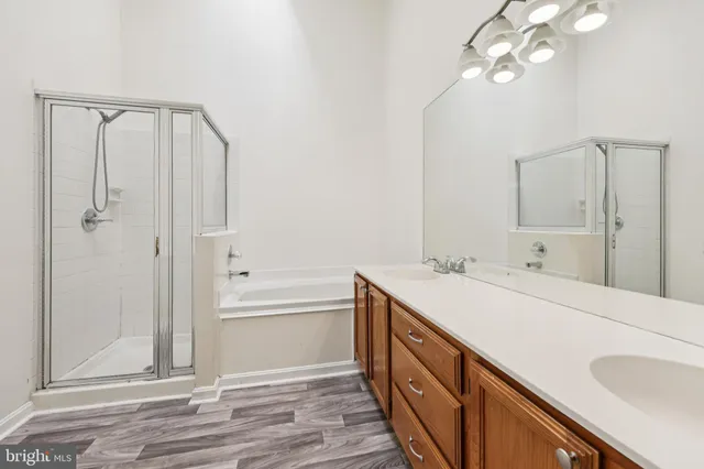 a bathroom with a double vanity sink mirror and shower