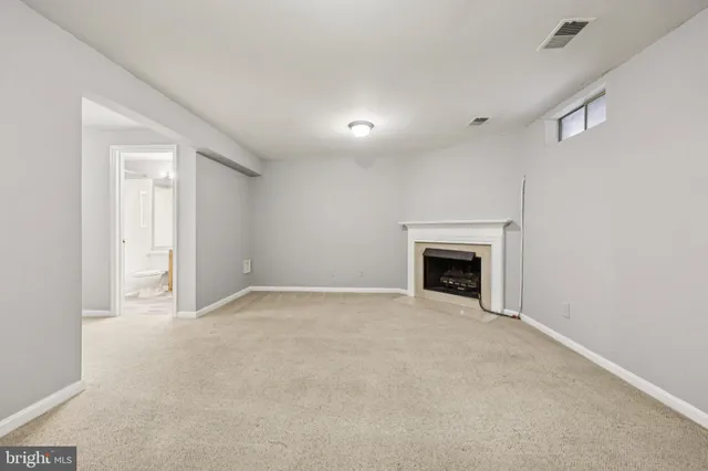 a view of an empty room with a fireplace