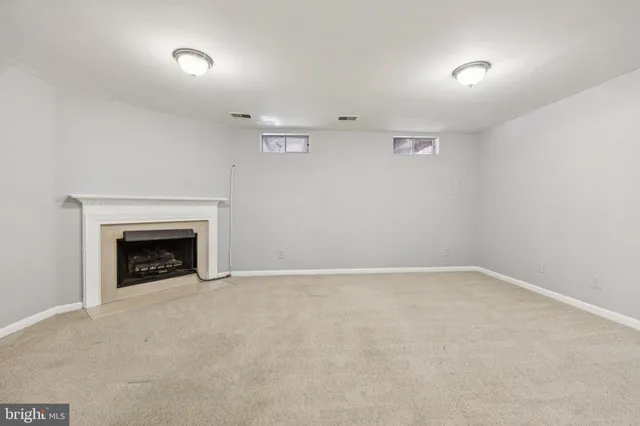 a view of an empty room with a fireplace