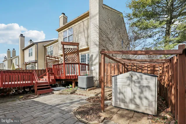 a view of a house with wooden fence