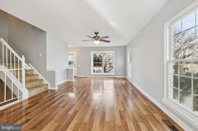 wooden floor in an empty room with a window