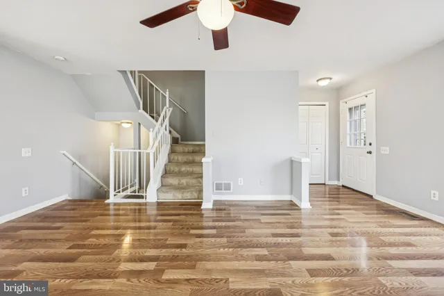 a view of entryway and hall with wooden floor