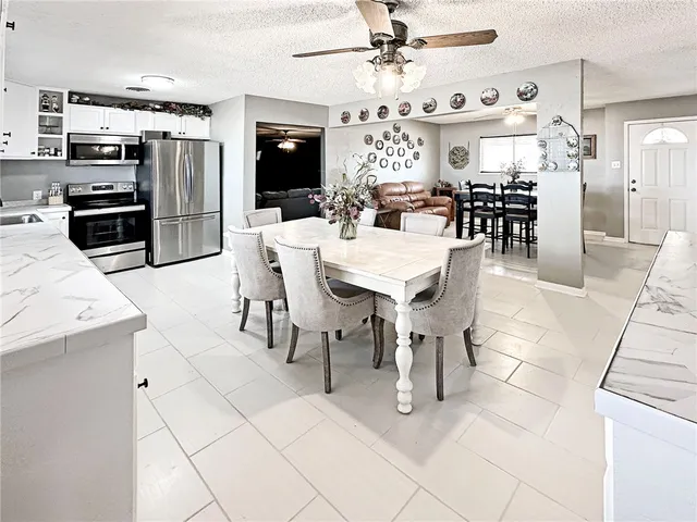 a large kitchen with a table and chairs