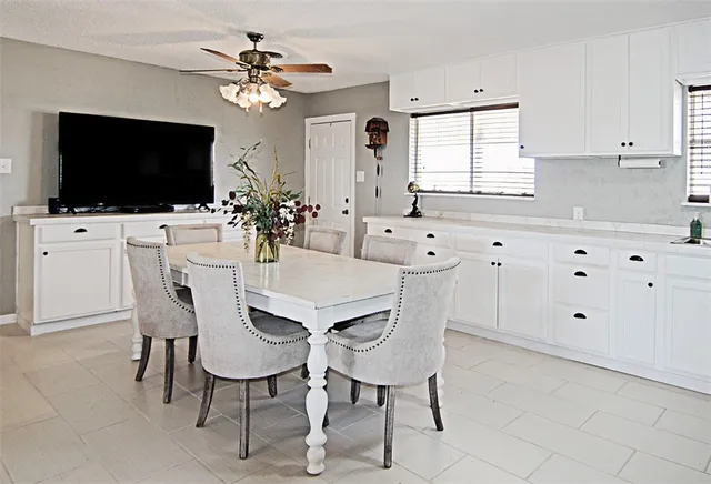 a view of a dining room with furniture and a flat screen tv