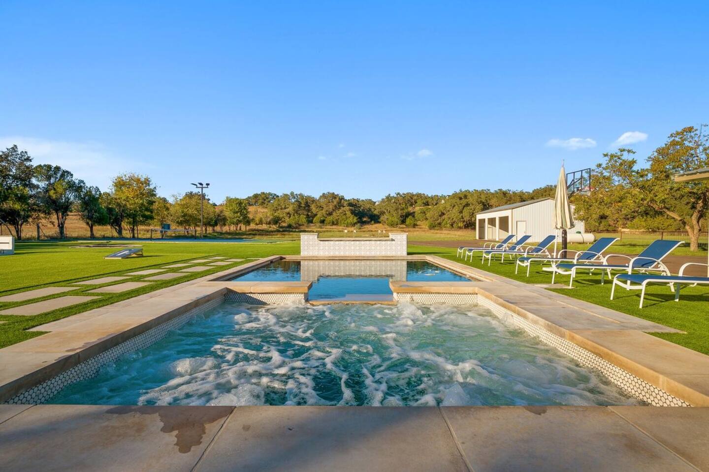 3500 Creek Road Dripping Springs, TX 78620 - Photo 19 of 21 Outdoor pool with a yard, an in-ground hot tub, and a patio