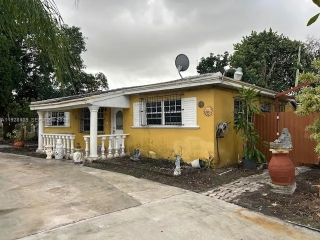 a front view of a house with sitting area