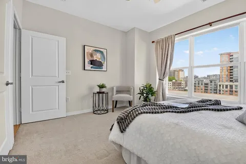 a kitchen with a refrigerator and white cabinets