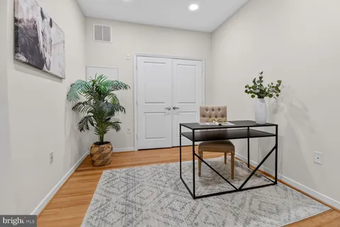 a living room with furniture and large windows