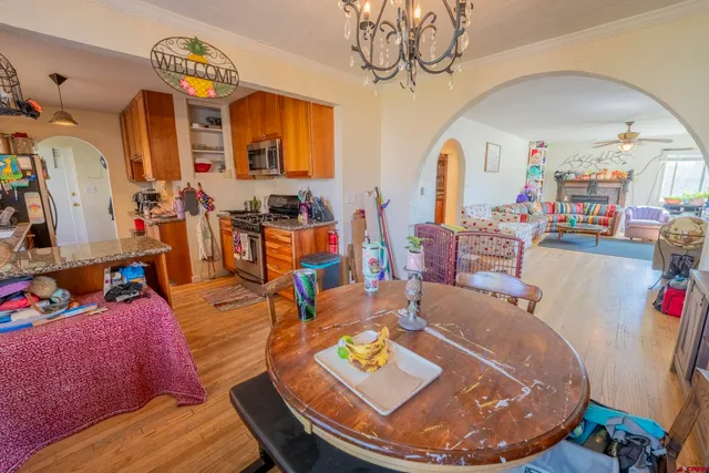 a kitchen with stainless steel appliances granite countertop a stove a sink dishwasher and cabinets with wooden floor