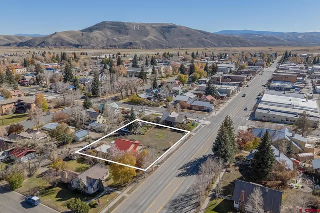 an aerial view of a house with a mountain