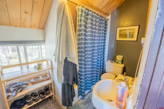 a living room with furniture a rug and a large window