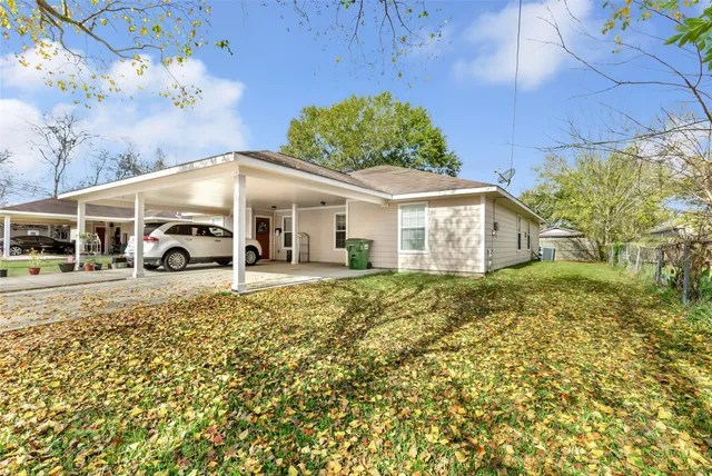 a white car parked in front of a house