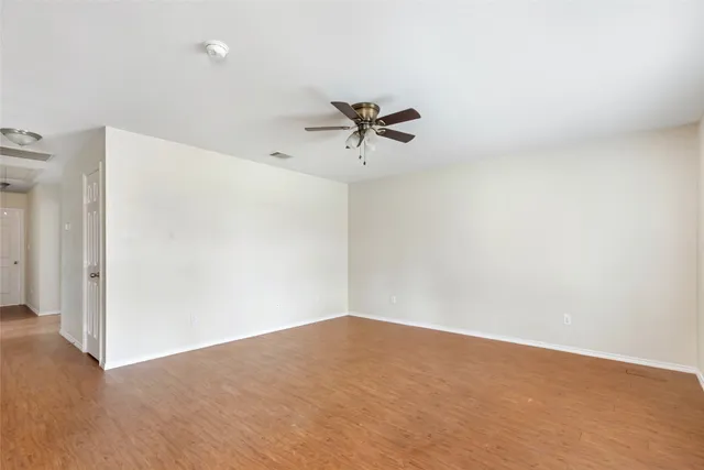 a view of a room with cabinet and a ceiling fan